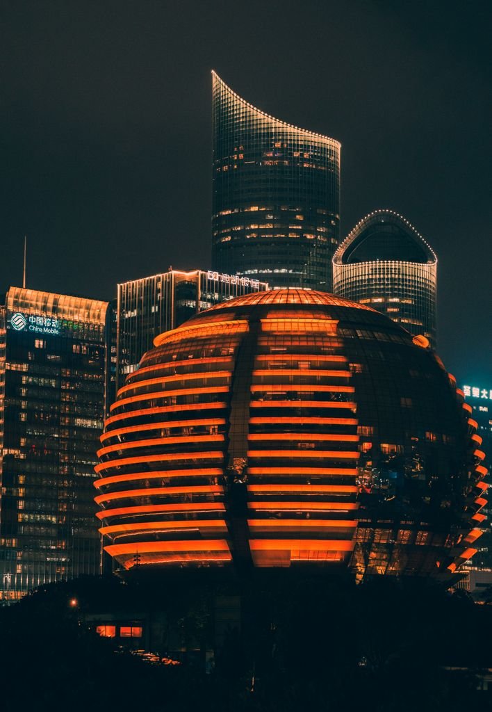 Stunning view of illuminated skyscrapers and urban architecture at night in Hangzhou.